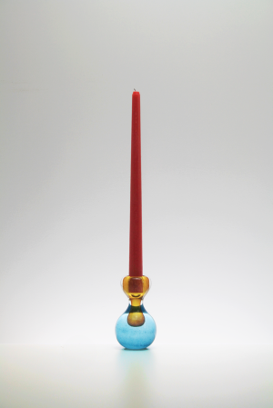 Orange and blue glass blown candlestick with red candle